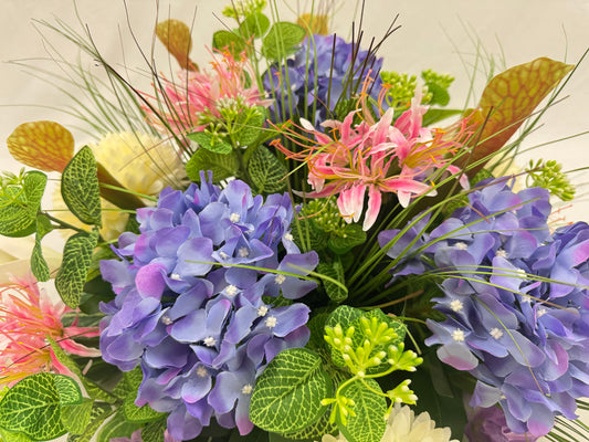 Close up van rouwstuk met roze en paarse bloemen