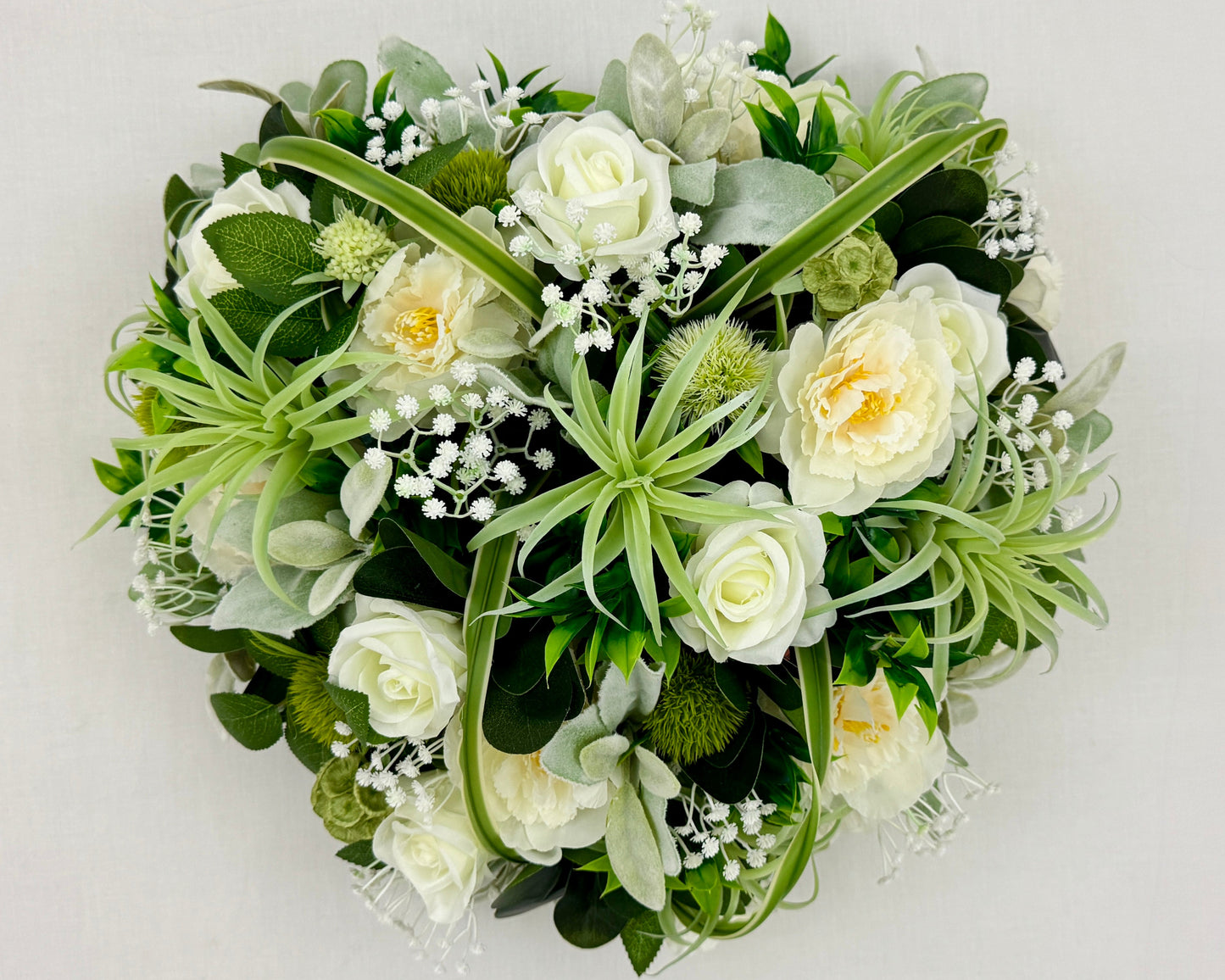 Groen rouwhart met vetplanten