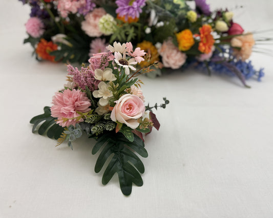 Mini-boeket roze bloemen met groot rouwstuk op achtergrond 